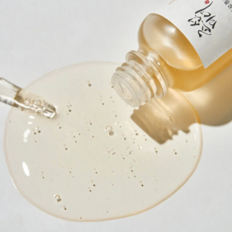 Beauty of Joseon Glow Serum in a glass bottle with a dropper, showcasing the golden serum texture and bubbles.